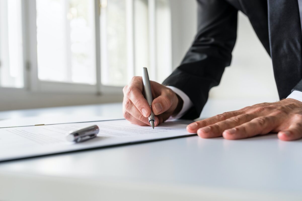 Businessman in office signing contract